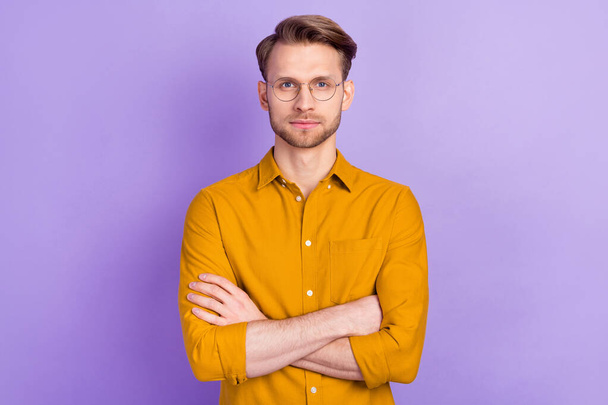 Photo of cute pretty young guy wear casual clothes glasses arms crossed isolated purple color background - Valokuva, kuva