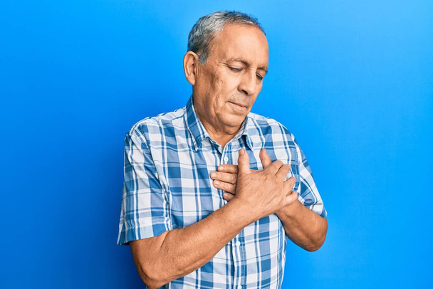 Senior hispanic man wearing casual clothes smiling with hands on chest, eyes closed with grateful gesture on face. health concept.  - Fotografie, Obrázek