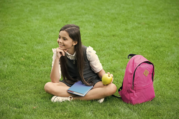 Your health is your wealth. Happy child relax on green grass. Healthy snack. School break. Health education. Natural diet. Dental health. Oral hygiene. Dental care habits. Child care and health - Photo, Image