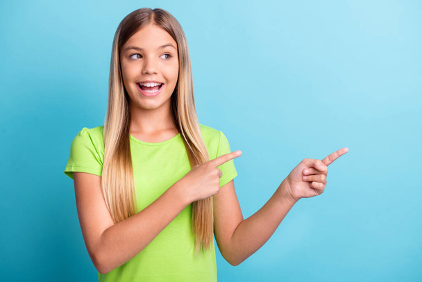 Photo of young cheerful positive good mood smiling girl pointing fingers copyspace isolated on blue color background - Φωτογραφία, εικόνα