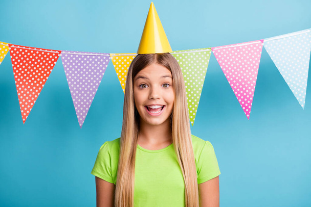 Photo of young happy excited positive good mood girl celebrating birthday wear cone cap isolated on blue color background - Photo, Image