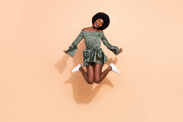 Full body photo of young african girl happy positive smile have fun jump active isolated over beige color background - Zdjęcie, obraz