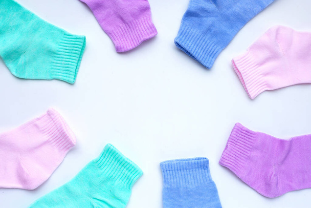 Frame made of colorful socks on white background.  - Foto, afbeelding