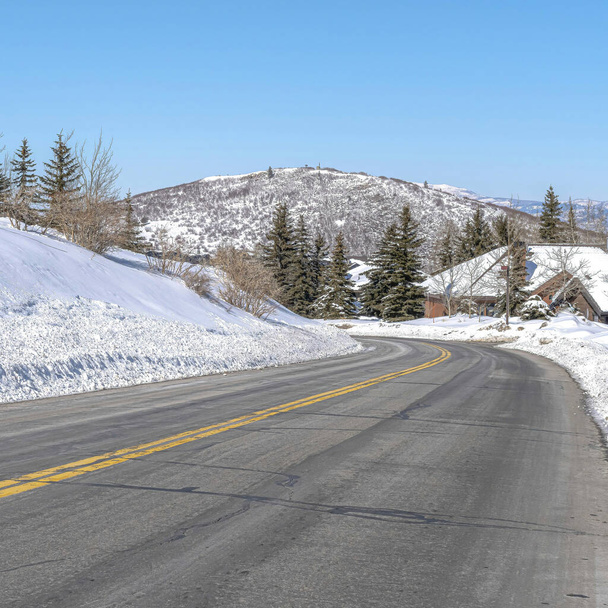 Square Park City landscape with paved mountain road on a scenic snowy scene in winter - Photo, Image