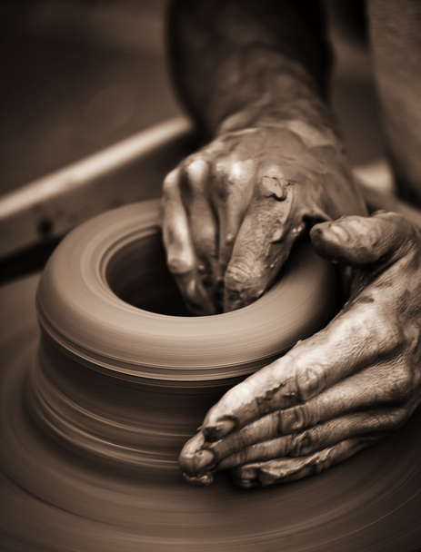 Hands working on pottery wheel - Foto, immagini