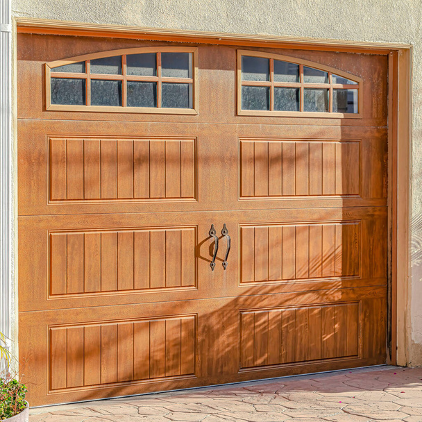 Square Brown glass paned wooden garage door of home in Huntington Beach California - Photo, Image