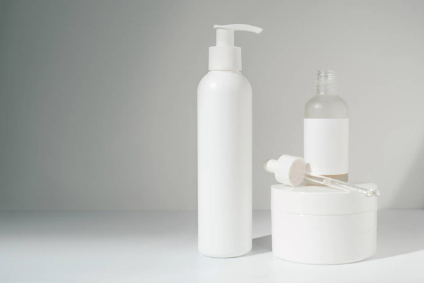Three jars of cosmetics stand on a white background. - Valokuva, kuva