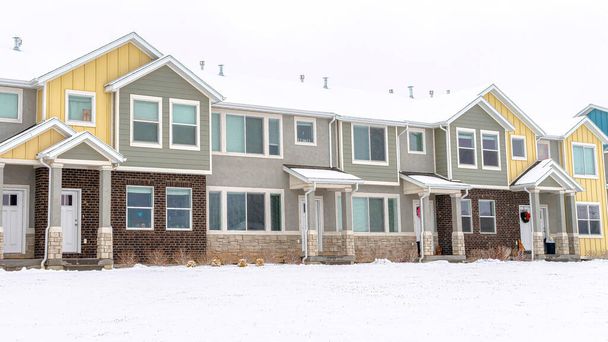 Pano Apartment houses in a snowy neighborhood with cloudy sky background in winter - Photo, Image
