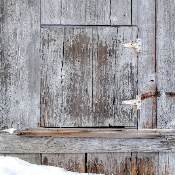 Square Close up of wooden building exterior with small square hinged window in winter - Fotografie, Obrázek