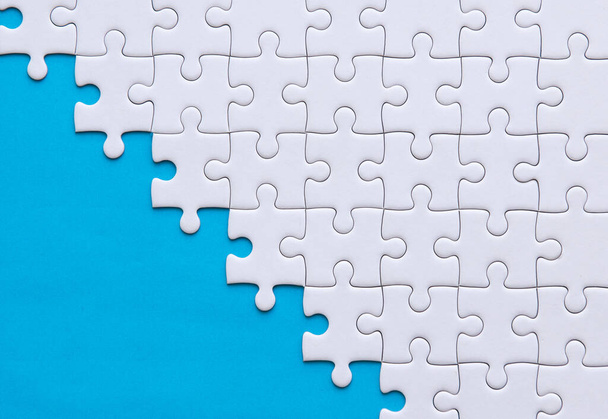 Jigsaw puzzle white color,Puzzles pieces grid,Success mosaic solution template,Horizontal on blue color background copy space for text,Top view - Foto, Bild