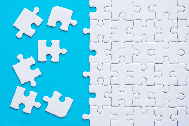 Jigsaw puzzle white color,Puzzles pieces grid,Success mosaic solution template,Horizontal on blue color background copy space for text,Top view - Fotó, kép