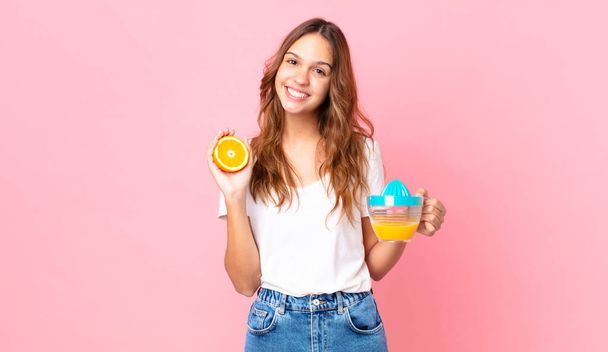 young pretty woman holding an orange juice - Zdjęcie, obraz