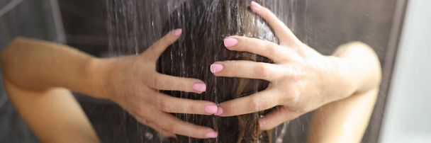 Woman takes shower in the bathroom closeup - Foto, imagen