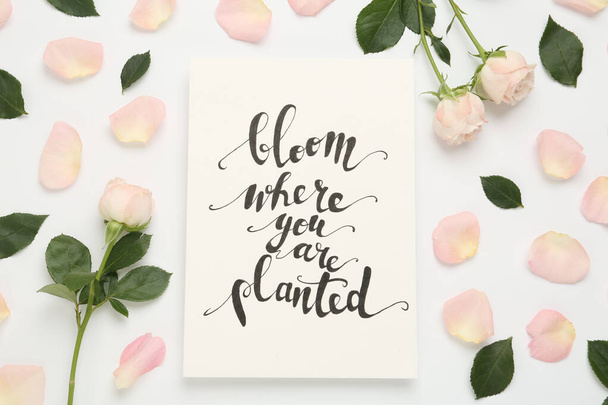 Frame of beautiful flowers and paper card with handwritten text Bloom where you are planted on white background, flat lay - Foto, Imagen