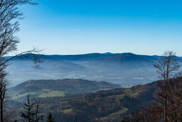 Moravskoslezske Beskydy mountains with Lysa hora hill from small forest glade bellow Velka Cantoryje hill summit in Slezse Beskydy mountains on czech - polish borders during autumn day with clear sky - Foto, Imagem