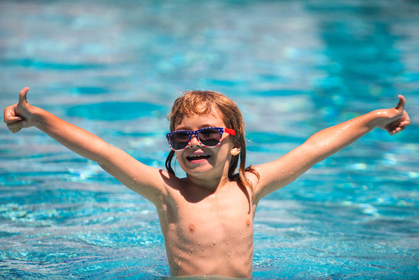 Activities child on the pool, children swimming and playing in water, happiness kids and summertime. Cute child boy swim in swimming pool, summer water background with copy space. Funny kids face. - Fotó, kép