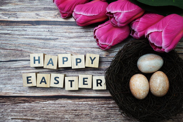 Happy Easter with flower and easter eggs decoration on wooden background - Foto, Imagen