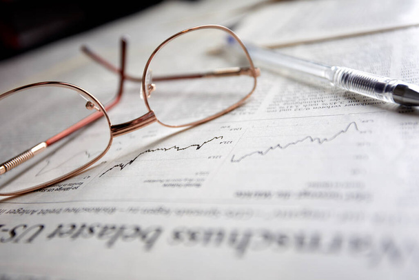 eyeglasses on business newspaper pages, close view  - Photo, Image