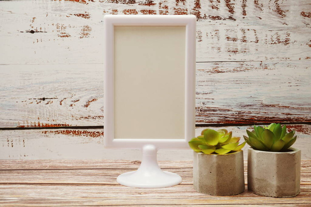 White mock up frame with Artificial Cactus and succulents decoration on wooden background - Fotografie, Obrázek
