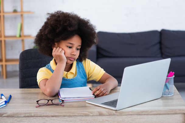 African american girl looking at laptop during online education at home  - Фото, зображення