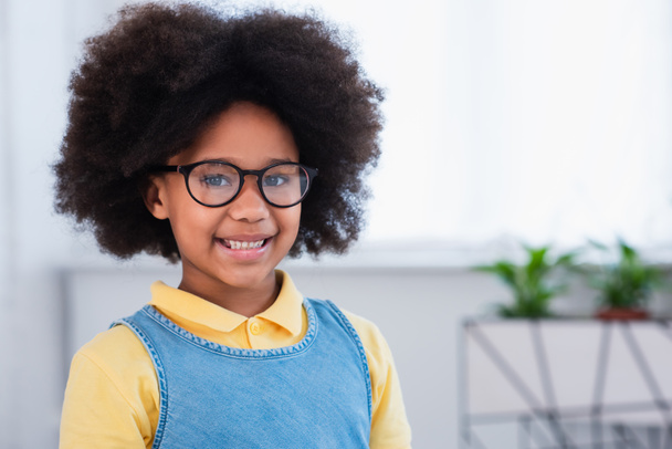 Smiling african american kid in eyeglasses looking at camera  - Fotó, kép