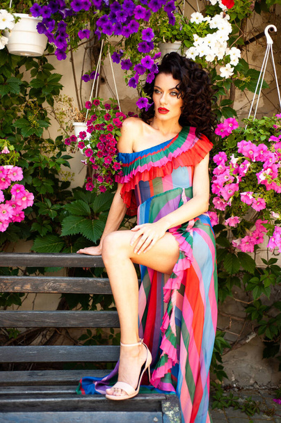 Attractive sensual woman wearing summer dress in the old city - Foto, imagen