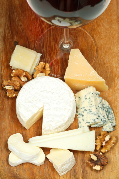 Glass of red wine and various cheeses - Photo, Image