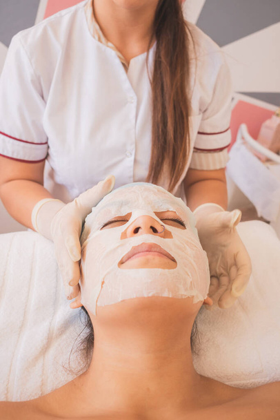 Young Woman Enjoying a Day at the Spa. Performing different treatments for the care of your skin and face. - Photo, Image