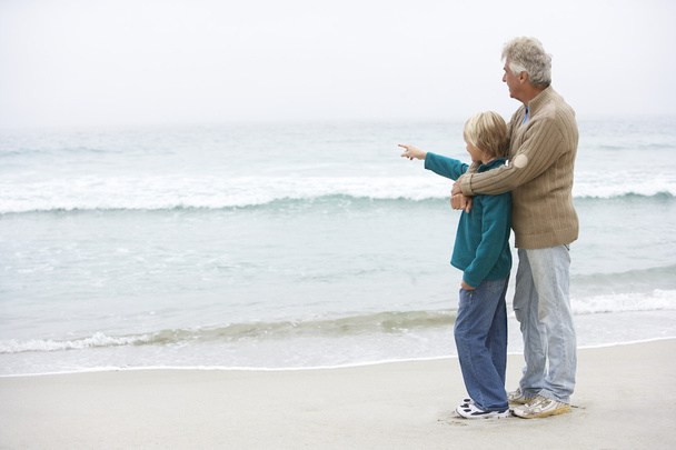 Grandfather And Son Standing On Winter Beach Together - Foto, imagen