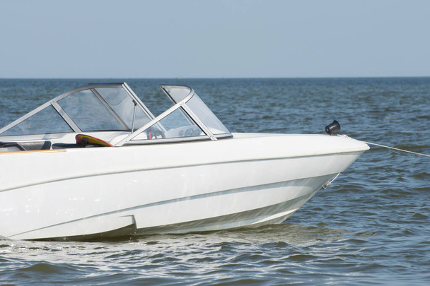 A white speedboat or motor boat sailing in the blue sea. Rest on a yacht. - Photo, Image