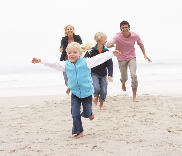 Young Family Running Along Winter Beach - Photo, image