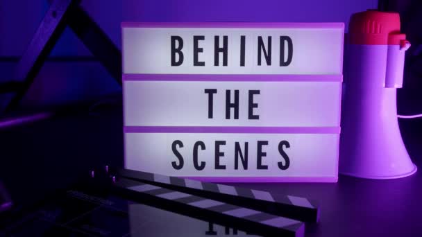 Behind the scenes lightbox in studio. letterboard text lightbox. Color light changing. Cinema Light box beside movie slate clapperboard megaphone and director chair. video production Behind the scenes - Footage, Video