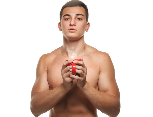 athletic guy holding a  cup  - Foto, afbeelding