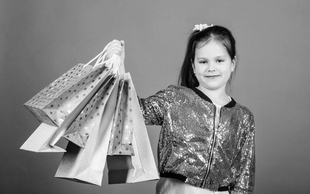 Great stores. Great choices. Girl with shopping bags violet background. Shopping and purchase. Black friday. Sale discount. Shopping day. Child hold bunch packages. Kids fashion. Surprise gift - Fotoğraf, Görsel