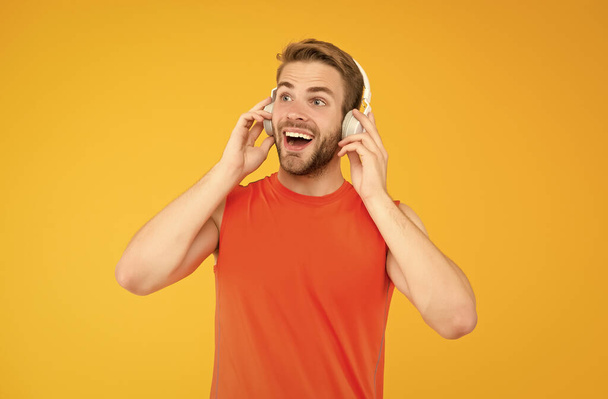 happy young man in sportswear wear modern headphones listening music while training, sport music - Фото, изображение