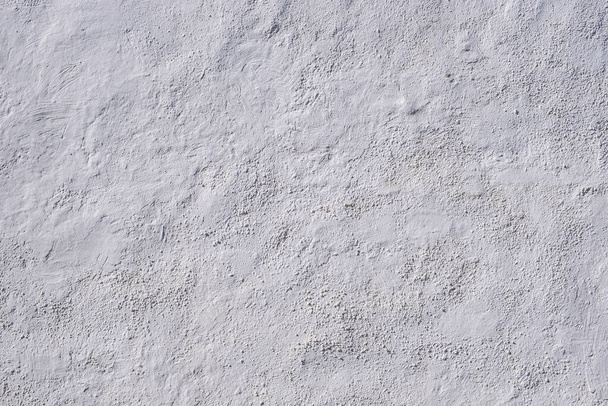 Textura de fondo de pared encalada. Superficie pintada de blanco, material común en las islas de Ciclades Grecia, para la higiene y la decoración exterior del edificio. Pintura tradicional de cal apagada también llamada merlán - Foto, imagen