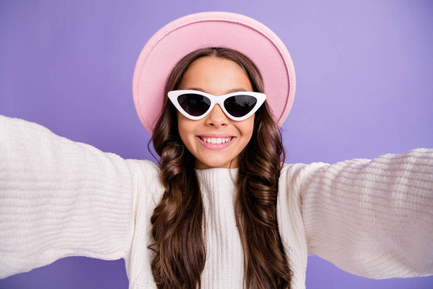 Photo of young pretty girl happy positive smile make take selfie travel trip wear sunglass isolated over purple color background - Fotó, kép
