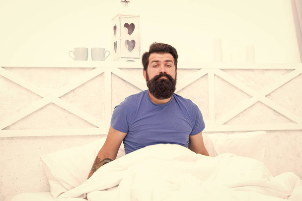 male body health. early wake up at morning. bachelor feel sleepy. guy at bedroom. lazy sunday. bed time routine. brutal male does not feel rested. relax lifestyle concept. tired bearded man in bed - Foto, Imagen