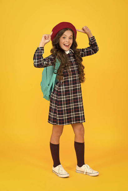 my new style. education concept. school and fashion. child in pupil uniform. kid in french beret on yellow background. stylish teen college student. little girl with backpack going to school - Photo, Image