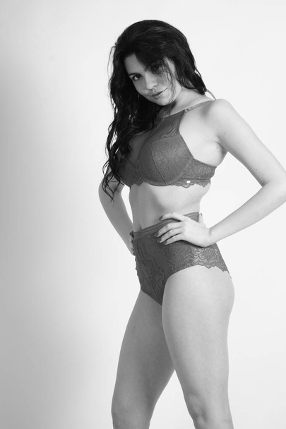 beautiful brunette woman wearing lingerie posing on white studio background - Valokuva, kuva