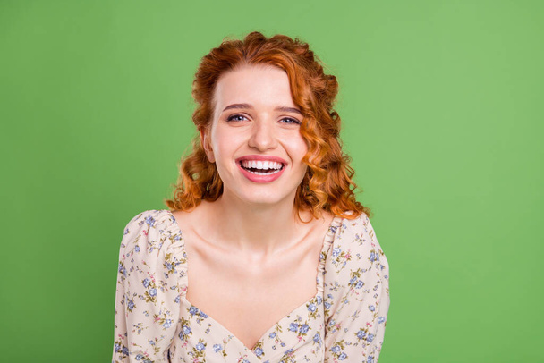Photo of positive joyful young woman smile ginger hair cheerful face isolated on vibrant green color background - Foto, immagini