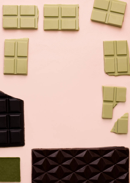 Different bars of chocolate on a pink background. View from above - Foto, afbeelding