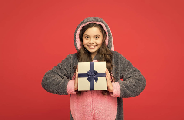 happy kid wear animal kigurumi pajamas and hold present box, happy birthday - Foto, imagen