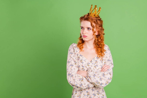 Photo of unhappy upset young offended woman crossed hands look empty space wear crown isolated on green color background - Fotografie, Obrázek