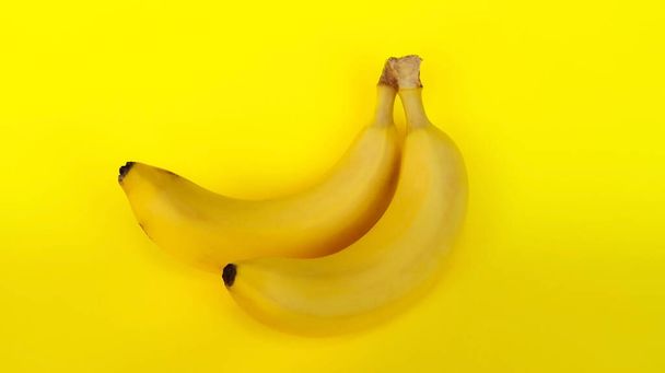 Two bananas on a yellow background - Φωτογραφία, εικόνα