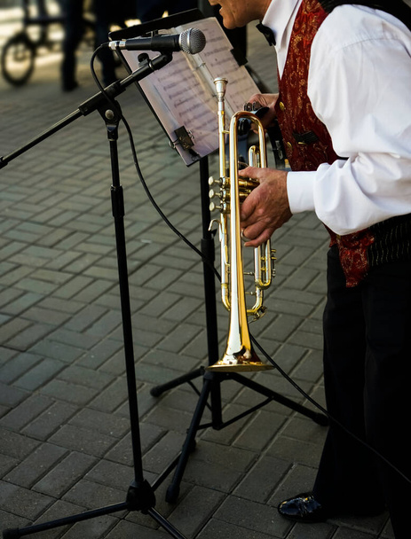 older man playing trumpet. Jazz Musician with Flugelhorn on street background.  - Foto, Imagem