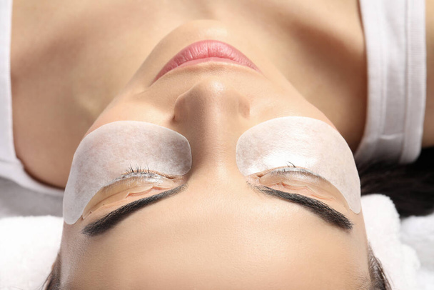 Young woman undergoing eyelash lamination, closeup. Professional service - Photo, Image