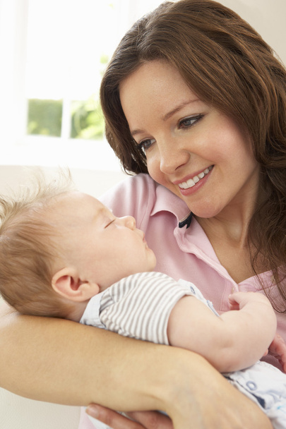 Close Up Of Affectionate Mother Cuddling Baby Boy At Home - Foto, Imagem