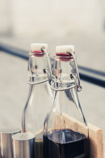 A vertical shot of glass bottles - Zdjęcie, obraz