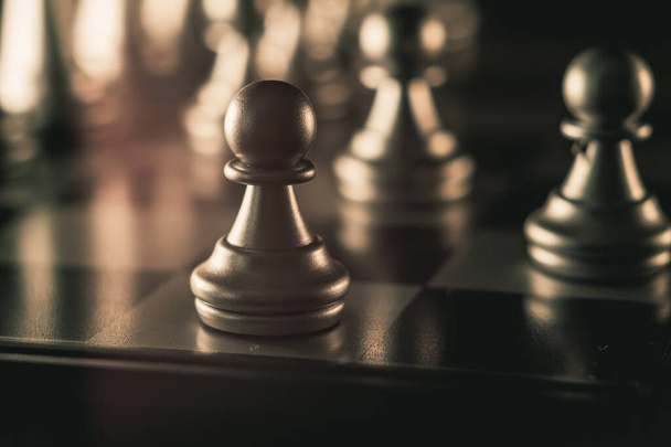 A closeup shot of the pawns on a chess board - Photo, image